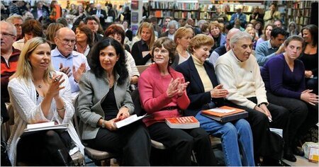 people sitting in a bookstore awaiting an event